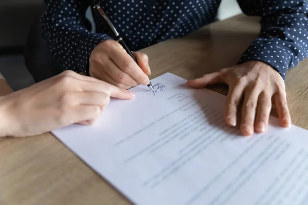 Close up young indian woman putting signature on hiring contract. — Stock Photo, Image