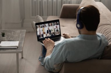 Erkek çalışanın dizüstü bilgisayarında webcam ekibi toplantısı var.