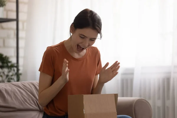 Excited girl unpack box with good quality order — Stock Photo, Image