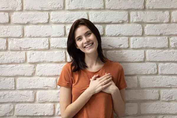 Portrait of smiling girl hold hands on chest — Stock Photo, Image