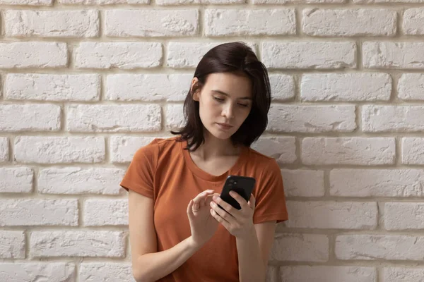 Millennial girl look at smartphone screen texting messaging — Stock Photo, Image