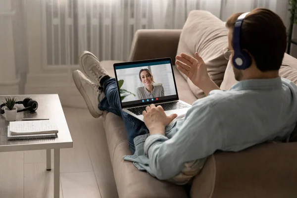Man in headphones speak on video call with female colleague — Stock Photo, Image