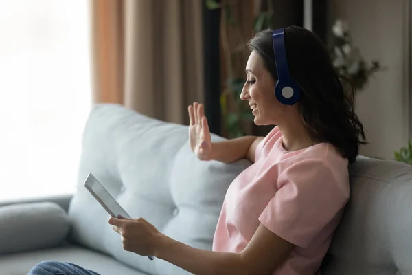 Smiling arabic woman talk on video call on pad