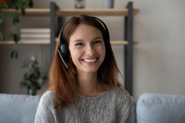 Headshot of smiling woman in headphones talk on video call — Stock Photo, Image