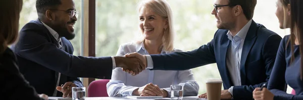 Happy diverse male business partners shaking hands — Stock Photo, Image