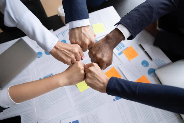 Group of diverse businesspeople teammates demonstrating partnership joining fists together — Stock Photo, Image