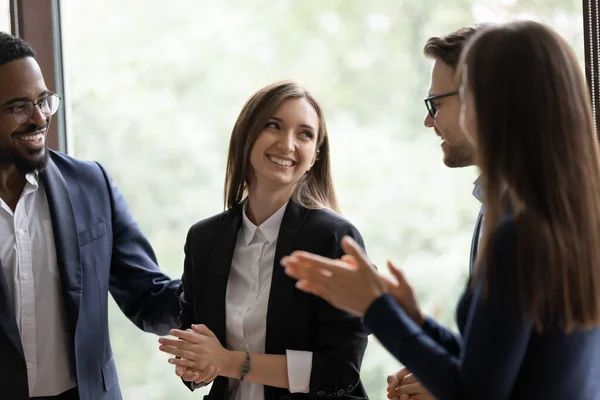 Diverse millennial colleagues meeting new female teammate in office — Stock Photo, Image