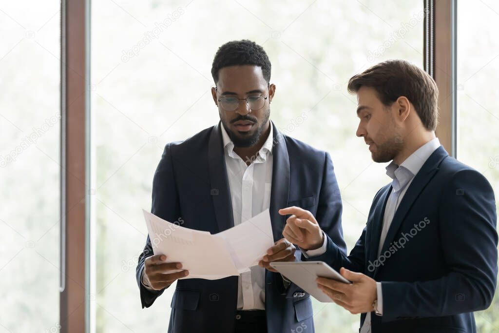 Caucasian manager explaining african client deal details