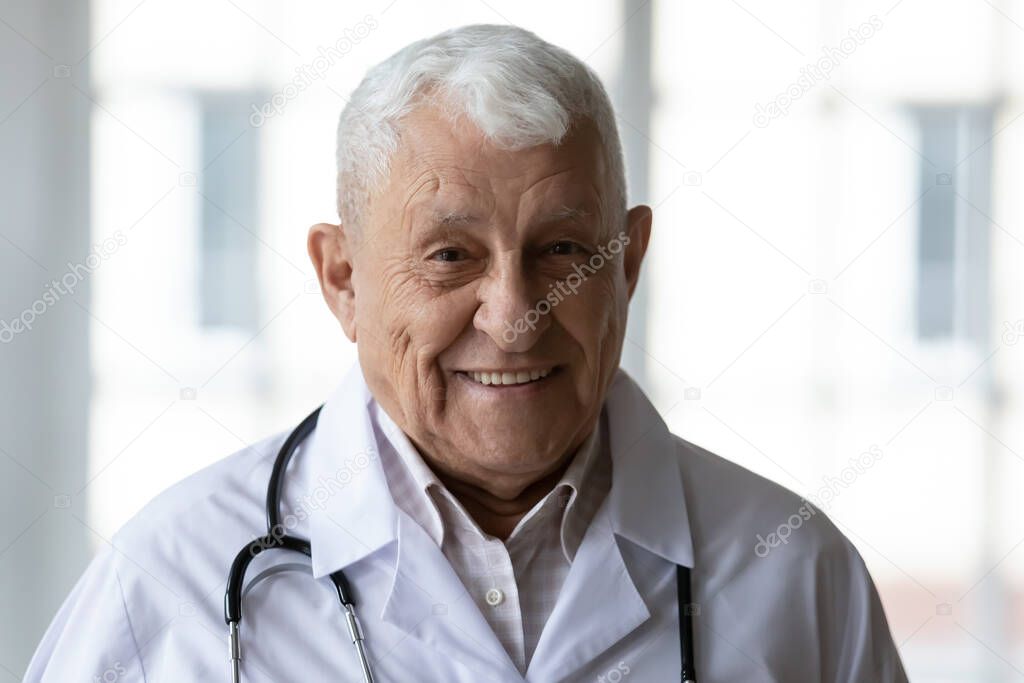 Portrait of skilled experienced trustful elderly 70s general practitioner.