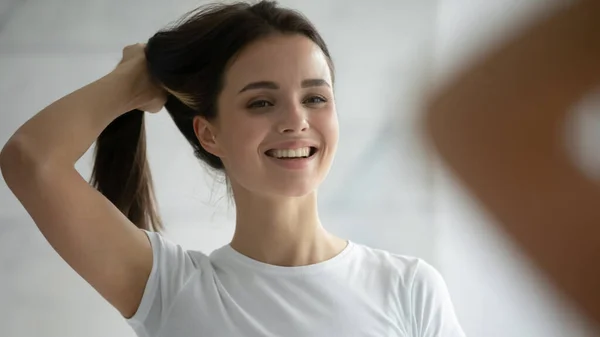 Close-up hoofd schot glimlachende jonge vrouw met haren, doen kapsel — Stockfoto