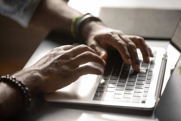Close up African American man typing on laptop keyboard — Stock Photo, Image