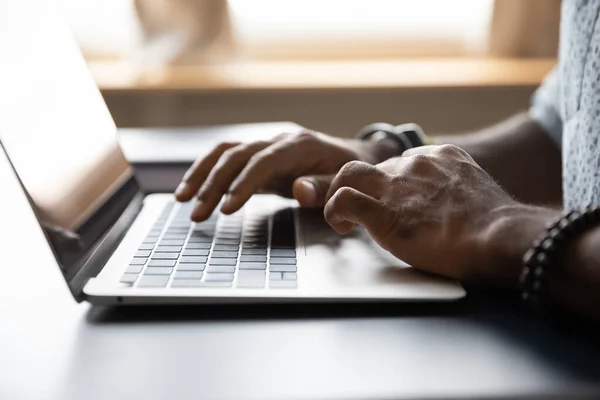 Close up African American male hands typing on laptop keyboard — Stock Photo, Image