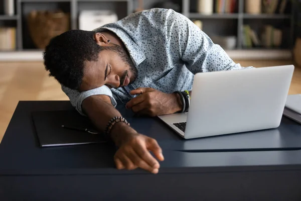 Exhausted tired African American businessman lying on desk and sleeping — Stock Photo, Image