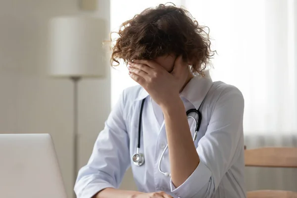 Close up unhappy stressed woman doctor covering face with hand — Stock Photo, Image