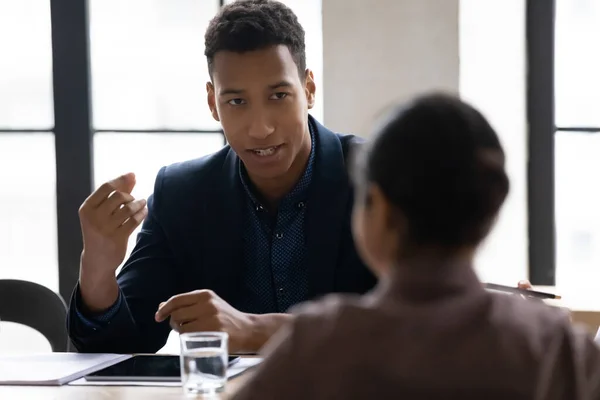 Young african american manager sharing project ideas with indian colleague. — Stock Photo, Image