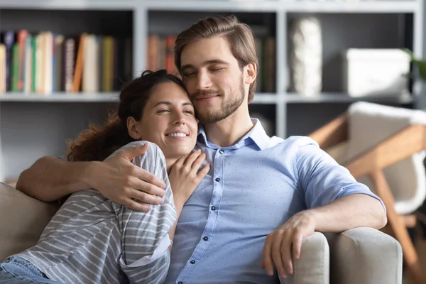 Loving devoted young handsome man cuddling attractive happy curly woman. — Stock Photo, Image