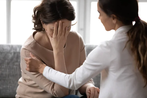 Compassionate kind young woman supporting depressed unhappy older mother. — Stock Photo, Image