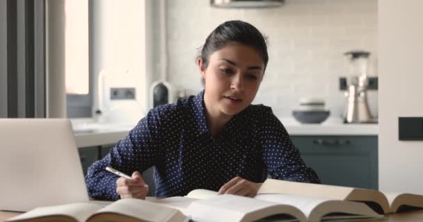 Indian student studying preparing for exams reading and writing — Stock Video