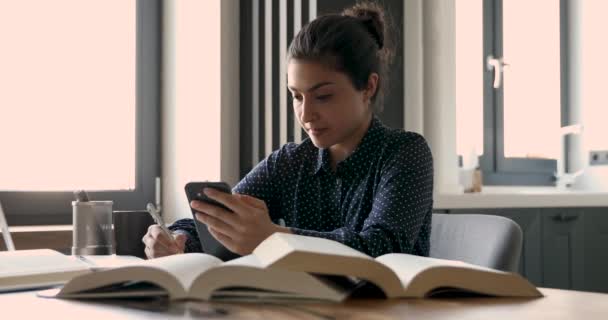 Indická studentka pomocí aplikace smartphone se připravuje na zkoušky v interiéru — Stock video