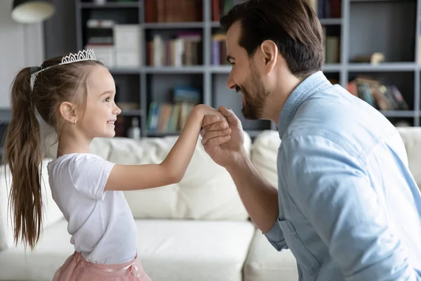 Close up loving father holding adorable little daughter hand — Stok Foto