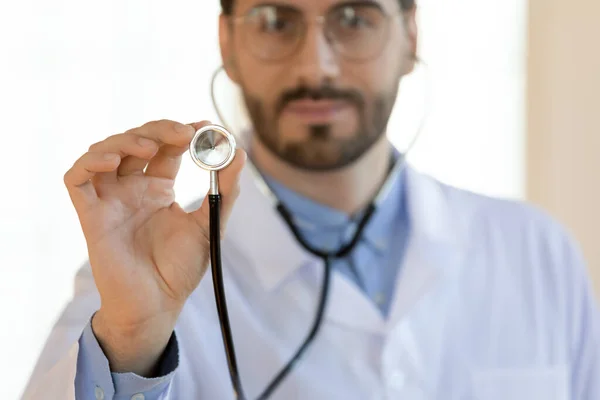 Zblízka vážný mladý lékař držení stetoskop, lékařské prohlídky koncept — Stock fotografie