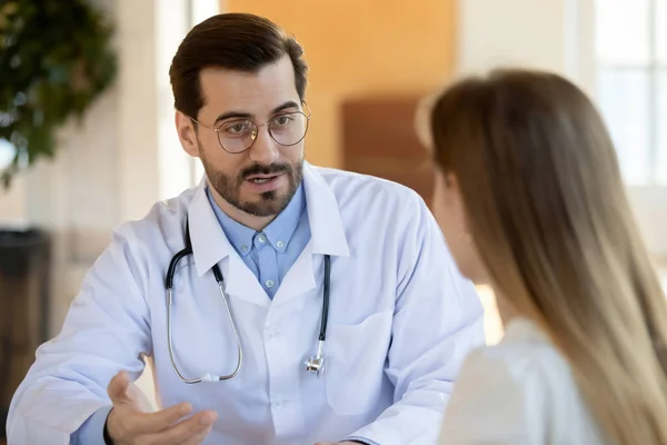 Close up confident doctor consulting young woman at meeting