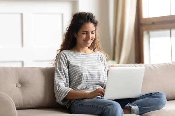 Woman sit on couch put notebook on laps texting email — Stock Photo, Image