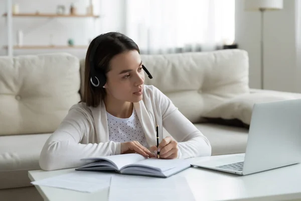 Pleasant young female PhD student watching educational lecture. — Stock Photo, Image