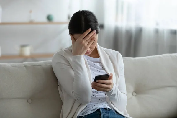 Mujer joven estresada sintiéndose confundida de notificación de malas noticias. —  Fotos de Stock
