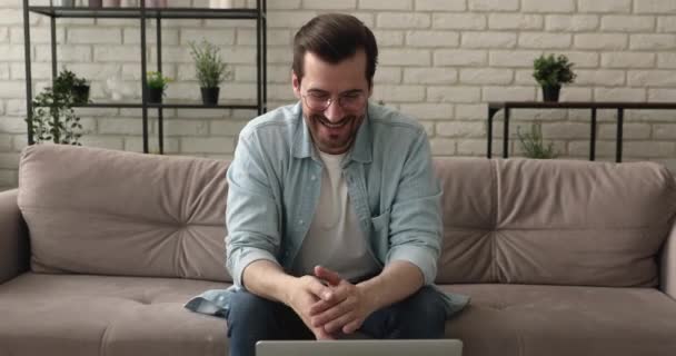 Hombre usando el ordenador portátil hablando por aplicación de videoconferencia — Vídeos de Stock