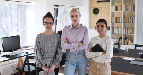 Diverse female colleagues posing three for corporate album in office — Stock video