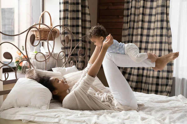 Happy young mixed race mother playing with cute small baby. — Stock Photo, Image