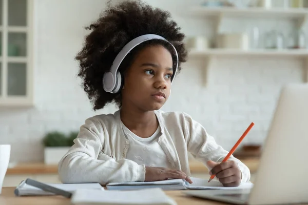 Little mixed race kid girl in headphones feeling tired. — Stock Photo, Image