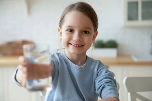 Small european child girl offering glass with fresh aqua. — Stock Photo, Image
