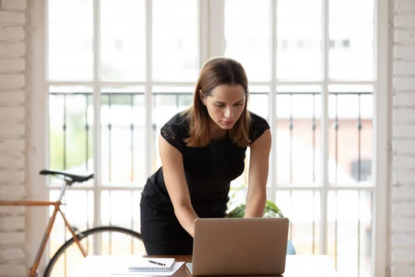 Focused Caucasian female employee work on laptop in office — Stock Photo, Image