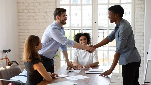 Smiling male colleagues handshake get acquainted at meeting — Stock Photo, Image