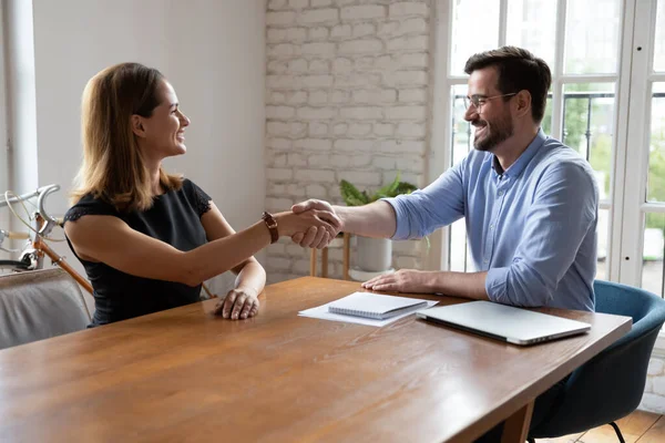 Male recruiter handshake greeting female job candidate — Stock Photo, Image