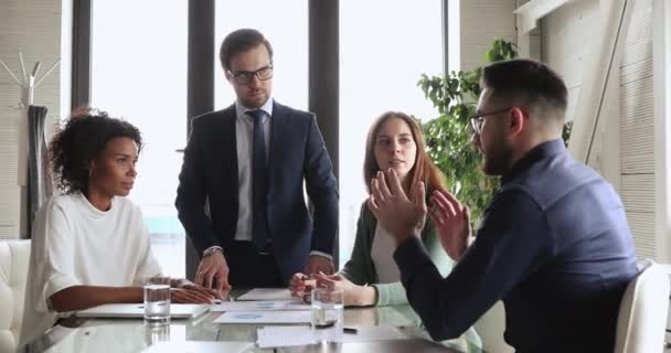 Serious arab boss explaining business project details to multiracial teammates. — Stock Video