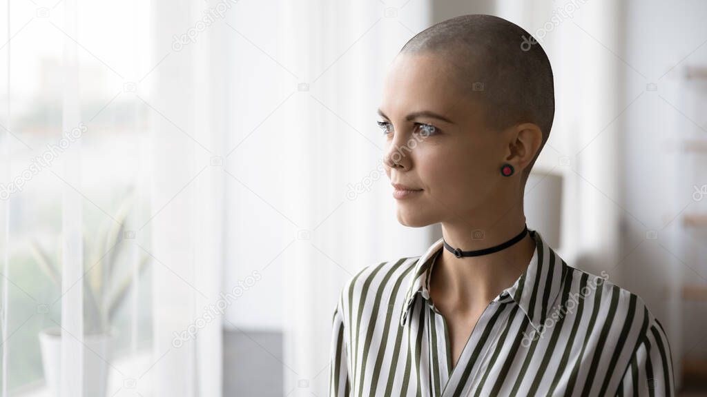 Young hairless woman look in distance thinking planning