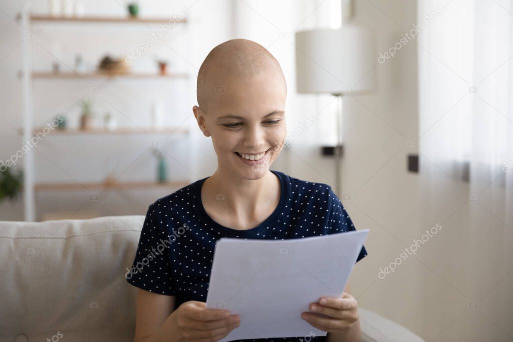 Smiling sick woman with cancer read good results in letter