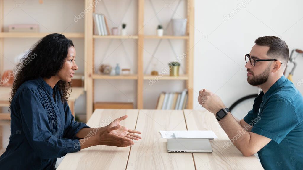 Confident hr manager holding interview with African American candidate