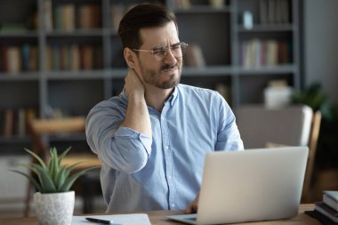 Sırt spazmından muzdarip genç, sağlıksız masaj boynu.