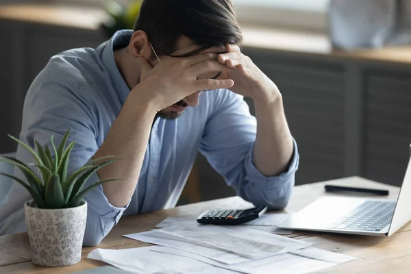 Unhappy young man distressed by financial problems