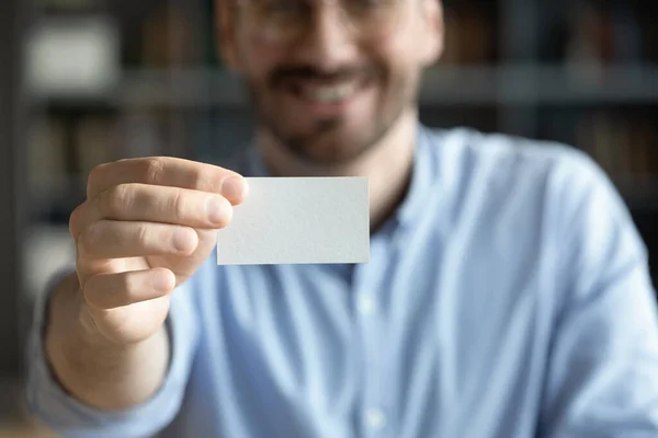 Close up of Caucasian male employee show business card — Stock Photo, Image