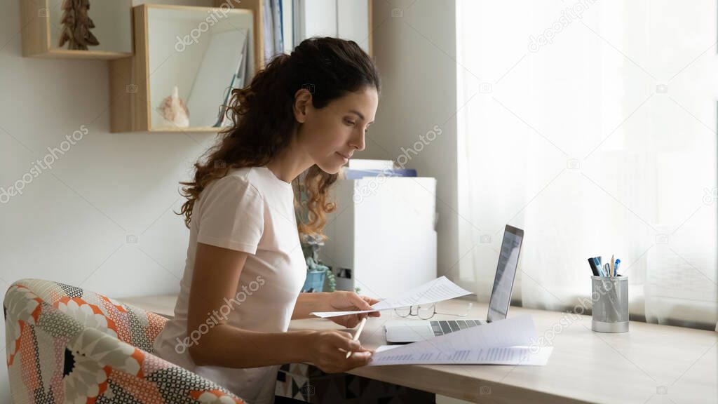 Focused woman work online on computer from home