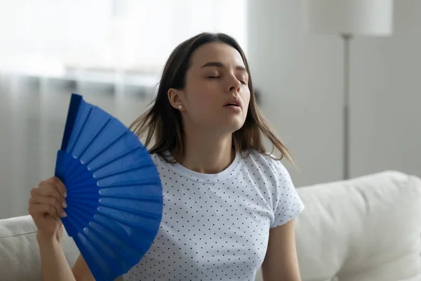 Overheated young woman wave with hand fan — Stock Image Overheated young woman wave with hand fan Royalty Free Stock Images