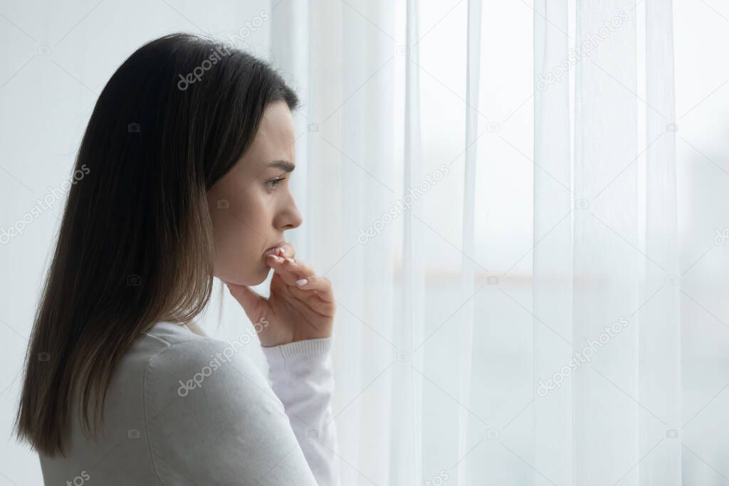 Pensive young woman look in distance thinking or pondering