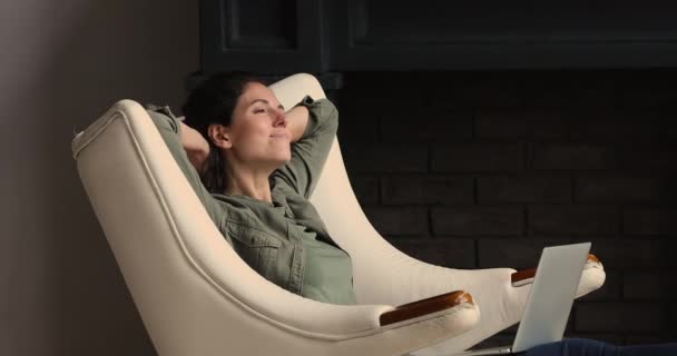 Female accomplish work on laptop relaxing in armchair indoor — Stock Video