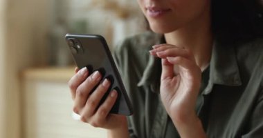Yakın çekim kadın elleri akıllı telefon tomarı haberlerini tutuyor.