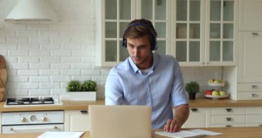 Kendine güvenen iş adamı uzaktan video uygulaması ve dizüstü bilgisayar kullanarak çalışıyor.